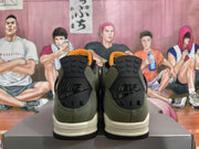 Rear view of the sneakers showing black heel panels and olive green uppers.