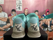 Rear view of light blue Nike Kyrie basketball shoes showing heel signatures and pale outsoles.
