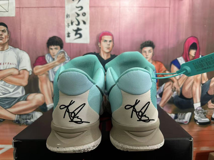 Rear view of light blue Nike Kyrie basketball shoes showing heel signatures and pale outsoles.