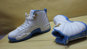 Three-quarter display of the pair showing the white uppers and blue outsoles.