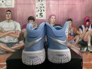 Rear view showing padded collars, metallic silver swooshes, blue heel panels, and textured outsoles with visible Zoom branding.
