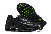 Pair of black Nike Shox Ride 2 sneakers, including a view of the outsole with green circular details.