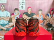 Rear view showing red Kyrie branding on the black heels and patterned red soles.