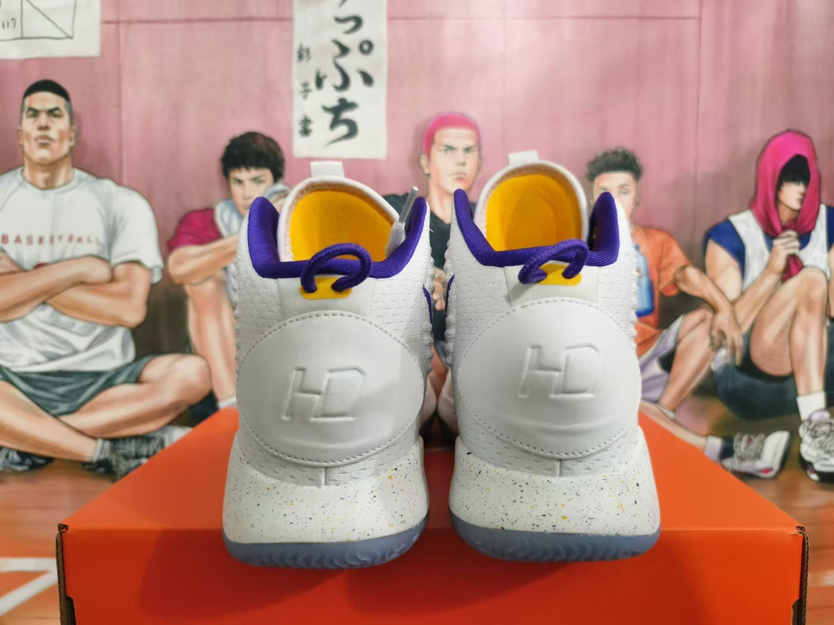 Rear view of white Nike Hyperdunk basketball shoes with purple collars, yellow lining, and speckled midsoles.