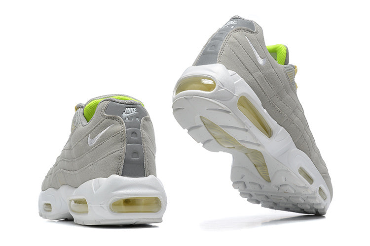 Nike Air Max 95 sneakers showing gray uppers, white soles, and visible air-unit windows from the heel and outsole.