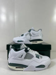 Close side view of one sneaker showing the white upper, mesh panel, green trim, and visible air window.