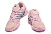 Front and angled views of pink Nike Sabrina 2 basketball shoes with teal details