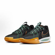 Pair of dark charcoal Nike basketball sneakers with green laces, orange accents, and gum-colored outsoles.