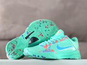 Kobe 5 Protro shoe pair with a view of the patterned outsole and turquoise upper.