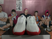 Front view of white basketball shoes with blue accents and red toe and outsole sections