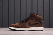 Side profile of one brown and black mid-top sneaker with perforated toe box and contrast sole.