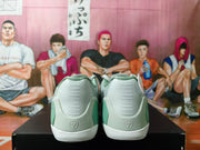 Rear view showing molded heel details on the mint-green and gray basketball shoes