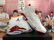 Two white Jordan high-top sneakers with red and orange accents shown at an angle.