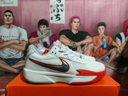 Side view showing the Nike Swoosh, red accents, textured upper and white midsole.