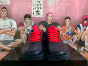Front view showing the pair's red laces, perforated toe panels, and navy uppers.