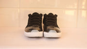 Front view of the pair showing black laces, dark metallic-look toe panels and white soles.