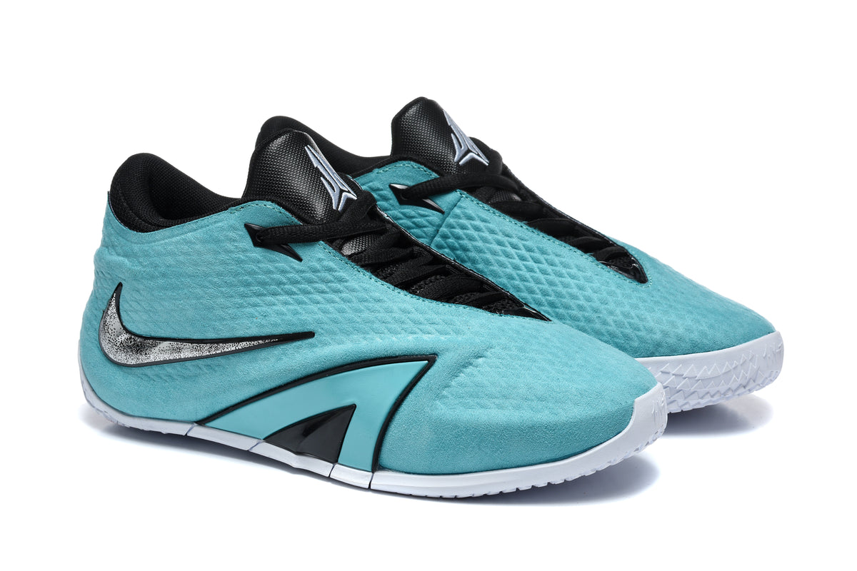 Pair of turquoise Nike low-top sneakers with black laces, silver-tone side logos, and white outsoles.