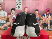 Front view of black and white Nike sneakers showing covered uppers, white Swoosh details, and contrasting toe and outsole sections.