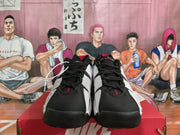Front view of a pair of black, white, and red Nike sneakers with black laces.