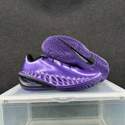 Electric purple Nike sneakers shown from the side and outsole, highlighting the textured traction pattern and Swoosh.