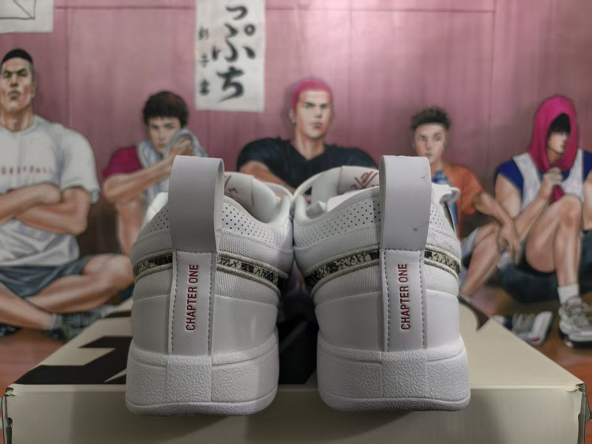Rear view of white Nike sneakers showing heel tabs with Chapter One text and perforated side panels.