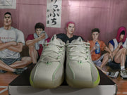 Front view of gray-green Nike sneakers with perforated toe boxes, pale green trim, and white laces.