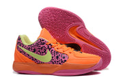 Jordan sneakers displayed with one shoe tilted to show the geometric pink rubber outsole pattern.