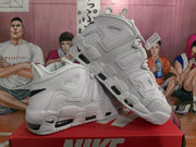 Angled view of the pair highlighting the layered side lettering, perforated panels and segmented sole.