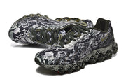 Close view of the patterned uppers, dark laces, and rounded sole cushioning elements.