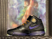 Close side view showing the perforated upper, purple side branding, and yellow laces.