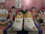 Front view showing tan tongues, white laces, and gold accents on Jordan basketball shoes.