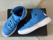 Pair of blue and white high-top basketball sneakers displayed on a black box.