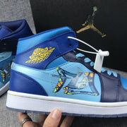 Close-up of the lateral side showing yellow wing branding, blue panels and the printed graphic overlay.
