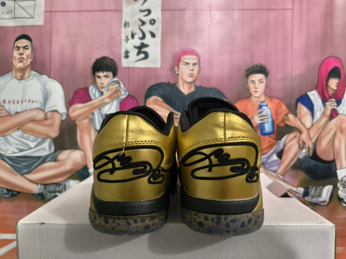 Rear view of metallic gold and black basketball shoes with spotted outsoles