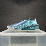 Side profile of an aqua-blue basketball shoe with white Swoosh and white outsole