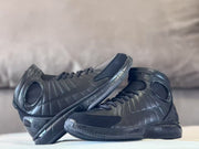 Pair of black high-top basketball shoes arranged in overlapping side views.