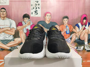 Front view of black basketball shoes with black laces and yellow tongue logos.