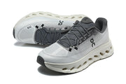 Pair of white and grey On running shoes shown from above and at an angle.