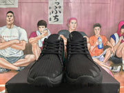 Front view of the black Jordan sneakers showing the rounded toe, black laces, and textured upper.