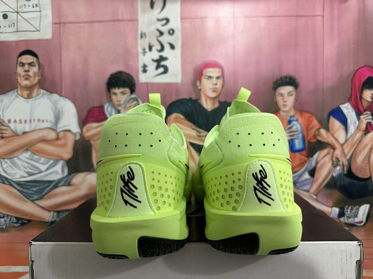 Rear view of vivid green Nike basketball shoes with perforated heels and Kobe signatures.