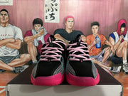 Front view of black Nike basketball shoes with pink laces and bright pink outsoles.