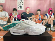 Side profile of a white Jordan shoe with navy details and a visible sole cushioning window.