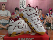 Angled product view showing the white upper, burgundy detailing, AIR side lettering and translucent gum-colored outsole.