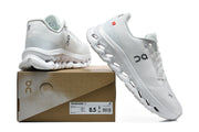White On Cloudmonster 3 shoes beside a box labeled Cloudmonster 3; the box label shows US size 8.5.