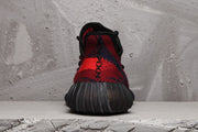 Rear view showing the black-and-red knit heel and ribbed dark outsole.