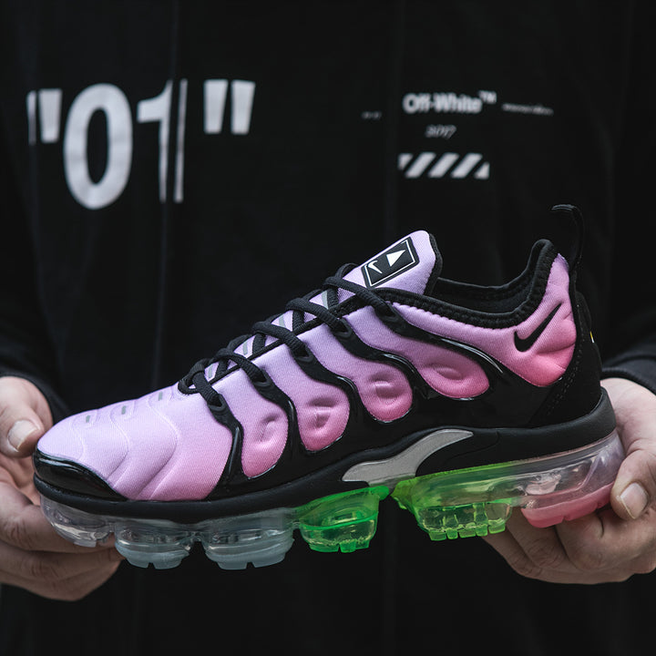 Pink and black Nike TN-21 sneaker with multicolor translucent sole, shown in profile