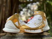 Pair of white and gold high-top sneakers with Kobe-style details