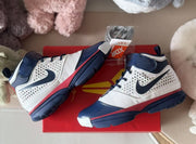 Overhead side view of the pair highlighting the navy, white, and red color blocking and outsole construction.