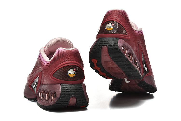 Rear and outsole views of pink gradient Nike Air Max DN sneakers.