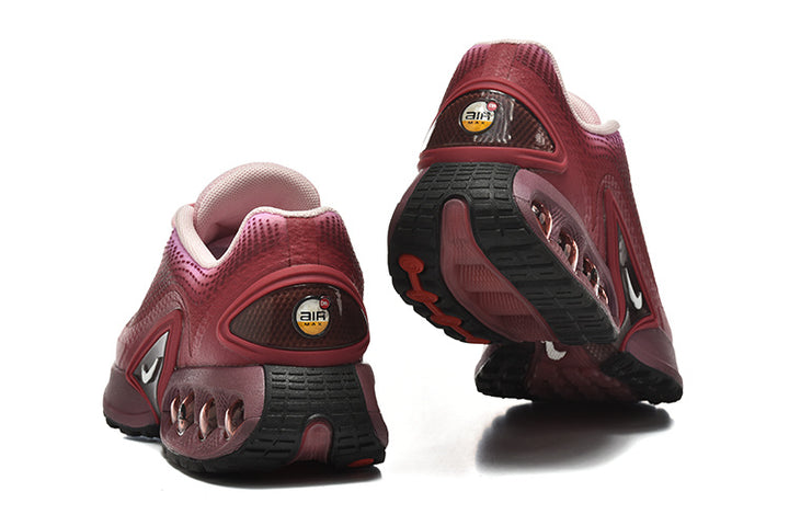 Rear and outsole views of pink gradient Nike Air Max DN sneakers.